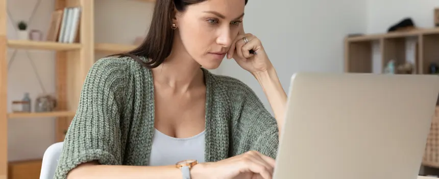 A person taking an online nursing course at home to further her nursing career