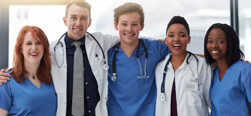 Nursing and physician colleagues smile in a group photo