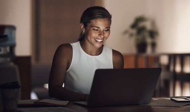 Online nursing learner taking a course on her laptop at night