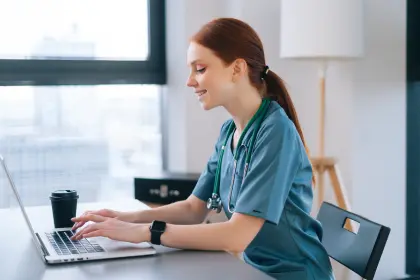 Working on an online bachelor's degree in nursing program on a computer