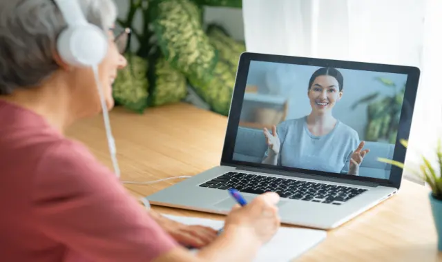 A learner is taking notes during an online nursing course