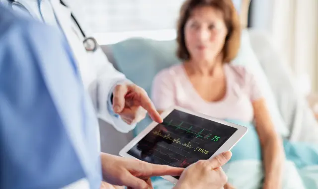 Nurse and Physician having a conversation with a patient